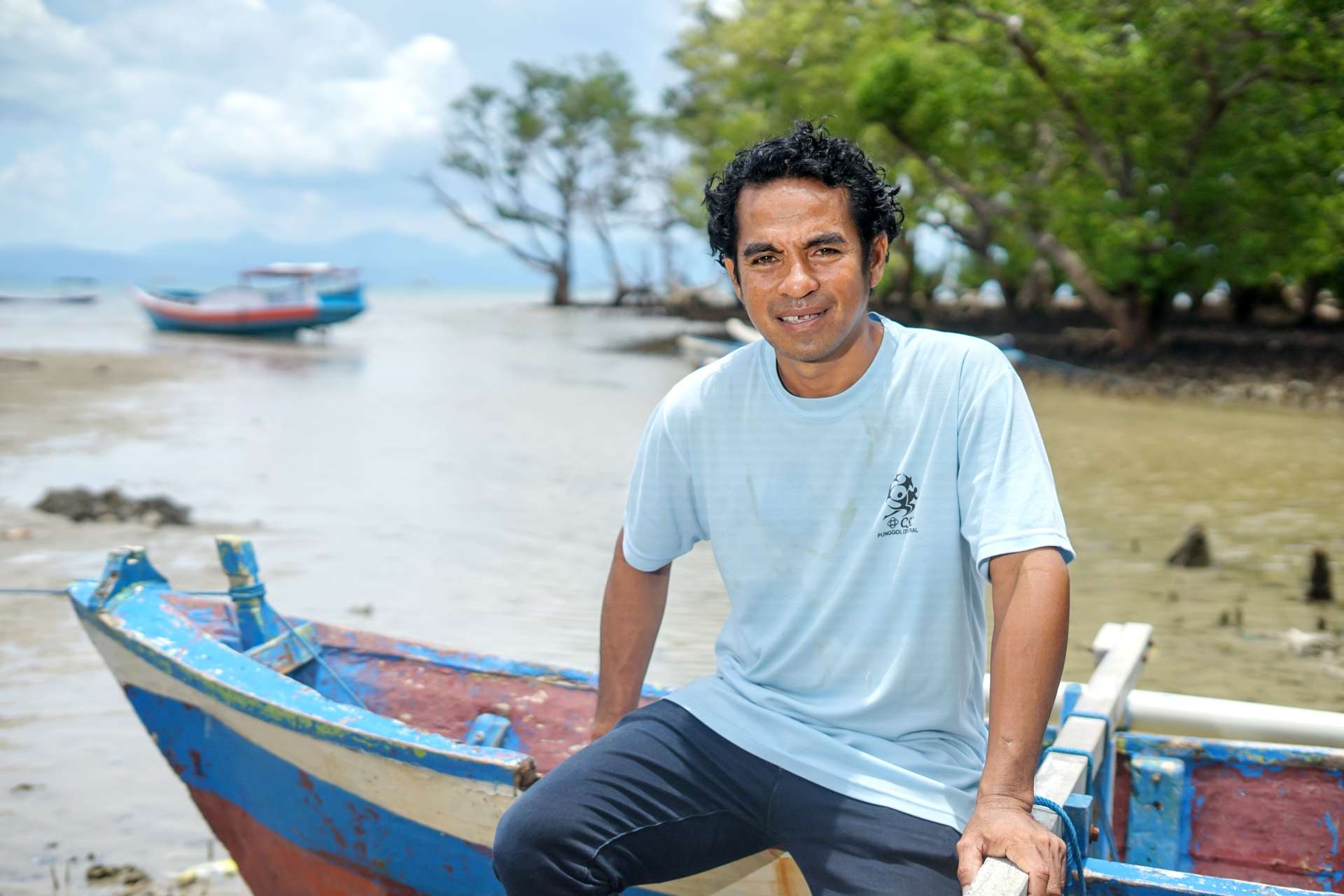 Joni plants mangroves to protect his community