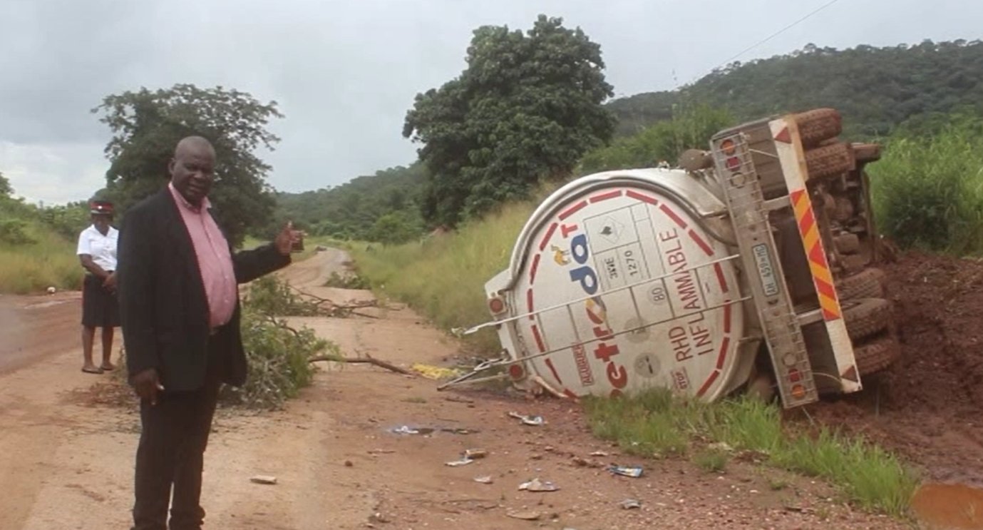 Richard Mabenga, the district commissioner of Rufunsa, next to an overturned truck 