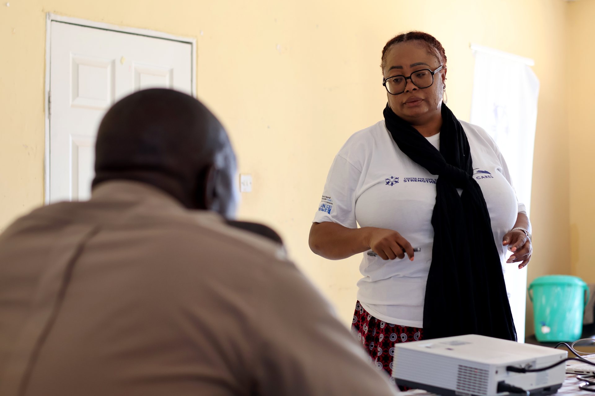 A CCSS trainer engages a police officer at a civic space workshop